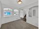 Open living room featuring archways, neutral carpet, and bright natural light at 4548 Quandary Peak St, Brighton, CO 80601