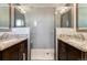 Modern bathroom featuring a glass shower and double sink vanity at 3807 S Jasmine St, Denver, CO 80237