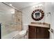 Bathroom with glass door shower, granite countertop, and modern fixtures at 3807 S Jasmine St, Denver, CO 80237