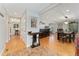 Open-concept living and dining area with hardwood floors and decorative lighting at 3807 S Jasmine St, Denver, CO 80237