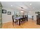 Bright dining room boasts hardwood floors and views from the bay window at 3807 S Jasmine St, Denver, CO 80237