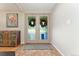 Inviting foyer with brick floors, decorative rug, and charming cabinet at 3807 S Jasmine St, Denver, CO 80237