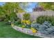 Landscaped garden bed with vibrant yellow flowers and lush greenery at 3807 S Jasmine St, Denver, CO 80237