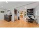 Open-concept living room and dining area with hardwood floors and modern finishes at 3807 S Jasmine St, Denver, CO 80237