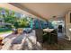 Covered patio with outdoor seating, dining area, and brick flooring at 3807 S Jasmine St, Denver, CO 80237