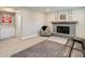 Basement living room featuring a fireplace and a built-in cabinet with white doors at 6071 S Ingalls St, Littleton, CO 80123