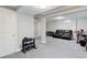 Open basement space with a sofa, exercise equipment, and ample room for activities at 6071 S Ingalls St, Littleton, CO 80123