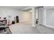 Finished basement with neutral carpet, column, and space for recreation and storage at 6071 S Ingalls St, Littleton, CO 80123