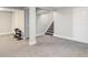 Finished basement featuring neutral carpet, stairs, and access doors, ready to be customized at 6071 S Ingalls St, Littleton, CO 80123
