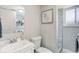 Bathroom featuring a single sink vanity and a shower over tub with gray tile surround at 6071 S Ingalls St, Littleton, CO 80123