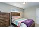 Comfortable bedroom featuring a wooden bed frame, wood chest-of-drawers and ample natural light at 6071 S Ingalls St, Littleton, CO 80123