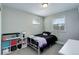Bright bedroom with a white iron bed frame, storage solutions, and natural light at 6071 S Ingalls St, Littleton, CO 80123