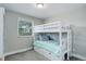 Bright bedroom featuring a white bunk bed and a window bringing in natural light at 6071 S Ingalls St, Littleton, CO 80123