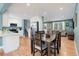 Open-concept living space flows into the dining area, featuring hardwood floors and natural light at 6071 S Ingalls St, Littleton, CO 80123