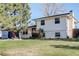 Charming two-story home with a well-maintained lawn and mature trees, perfect for suburban living at 6071 S Ingalls St, Littleton, CO 80123