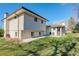 Back exterior featuring a well-maintained lawn, patio, and siding in a desirable neighborhood at 6071 S Ingalls St, Littleton, CO 80123