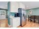 A modern stainless steel refrigerator and white cabinets complement the contemporary kitchen space at 6071 S Ingalls St, Littleton, CO 80123