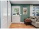Cozy living room features a glass-paned exterior door and warm natural light at 6071 S Ingalls St, Littleton, CO 80123