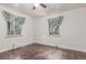 Bedroom with dark hardwood floors, white walls, and two windows with curtains at 3280 Ames St, Wheat Ridge, CO 80212