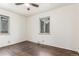 Bedroom with hardwood floors, white walls, and two windows at 3280 Ames St, Wheat Ridge, CO 80212