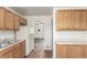 Traditional kitchen with oak cabinets and open layout that leads to the living room at 3280 Ames St, Wheat Ridge, CO 80212