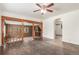 Open living room with hardwood floors, wood-paneled accent wall, and steps to carpeted area at 3280 Ames St, Wheat Ridge, CO 80212