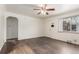 Bright living room featuring hardwood floors, a ceiling fan, and a front door entrance at 3280 Ames St, Wheat Ridge, CO 80212