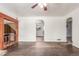 Spacious living room with hardwood floors, white walls, and archway to the kitchen at 3280 Ames St, Wheat Ridge, CO 80212