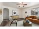 Living room featuring hardwood floors and virtually staged with seating and decor at 3280 Ames St, Wheat Ridge, CO 80212