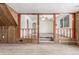 Open-concept living space with carpeted steps, wood railing, and large picture window at 3280 Ames St, Wheat Ridge, CO 80212