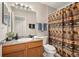 Bathroom featuring a wood vanity, large mirror, and a shower with a decorative bear-themed curtain at 23585 Genesee Village Rd # E, Golden, CO 80401