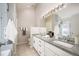 Well-lit bathroom with double vanity, granite countertops, and tiled shower at 23585 Genesee Village Rd # E, Golden, CO 80401