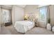 Bedroom featuring large windows for ample natural light, neutral walls, and plush carpeting at 23585 Genesee Village Rd # E, Golden, CO 80401