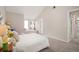 Bright bedroom features neutral walls, vaulted ceiling, multiple windows and plush carpeting at 23585 Genesee Village Rd # E, Golden, CO 80401