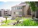 Inviting multi-level condo with a well-maintained lawn and charming landscaping with mature trees and colorful flowers at 23585 Genesee Village Rd # E, Golden, CO 80401