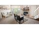 Bright living room featuring a stone fireplace, plush seating, and a sliding door to the outdoor area at 23585 Genesee Village Rd # E, Golden, CO 80401