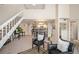 Open-concept living room boasts two-story ceilings, a staircase, and an open flow into the dining and kitchen areas at 23585 Genesee Village Rd # E, Golden, CO 80401