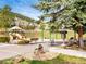 Community playground featuring a slide, swings, and seating at 23585 Genesee Village Rd # E, Golden, CO 80401