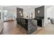 Stylish bar area featuring marble countertops, seating for four, and a view of the adjacent dining and living spaces at 4736 S Fillmore Ct, Cherry Hills Village, CO 80113