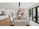 Open-concept dining area with a long wooden table, twelve white chairs, and a chandelier above the table at 4736 S Fillmore Ct, Cherry Hills Village, CO 80113