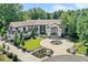 Beautiful home with circular driveway, fountain, manicured lawn, mature trees, and an impressive entrance framed with black trim at 4736 S Fillmore Ct, Cherry Hills Village, CO 80113