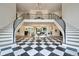 Grand foyer with a black and white checkered floor, a split staircase, and views into other living spaces at 4736 S Fillmore Ct, Cherry Hills Village, CO 80113