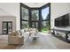 Bright Gathering room with wall of windows and large sectional sofa at 4736 S Fillmore Ct, Cherry Hills Village, CO 80113
