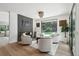Inviting living room with a modern fireplace, four swivel chairs, and large window providing views of the serene backyard at 4736 S Fillmore Ct, Cherry Hills Village, CO 80113