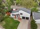 Aerial view of home featuring a manicured lawn, two-car garage, and natural wood porch supports at 4484 S Granby Ct, Aurora, CO 80015