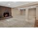 Spacious basement area with a brick fireplace, neutral carpet, and a partially open floor plan at 4484 S Granby Ct, Aurora, CO 80015
