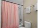 Bathroom with a shower-tub combo featuring a pink shower curtain at 4484 S Granby Ct, Aurora, CO 80015