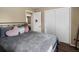 Bedroom featuring a metal frame bed and closet with white sliding doors at 4484 S Granby Ct, Aurora, CO 80015