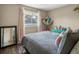 Bedroom with plush gray comforter, toys, and natural light from the window at 4484 S Granby Ct, Aurora, CO 80015