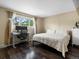 Bedroom featuring dark floors, a bed, desk and a nice view from the window at 4484 S Granby Ct, Aurora, CO 80015
